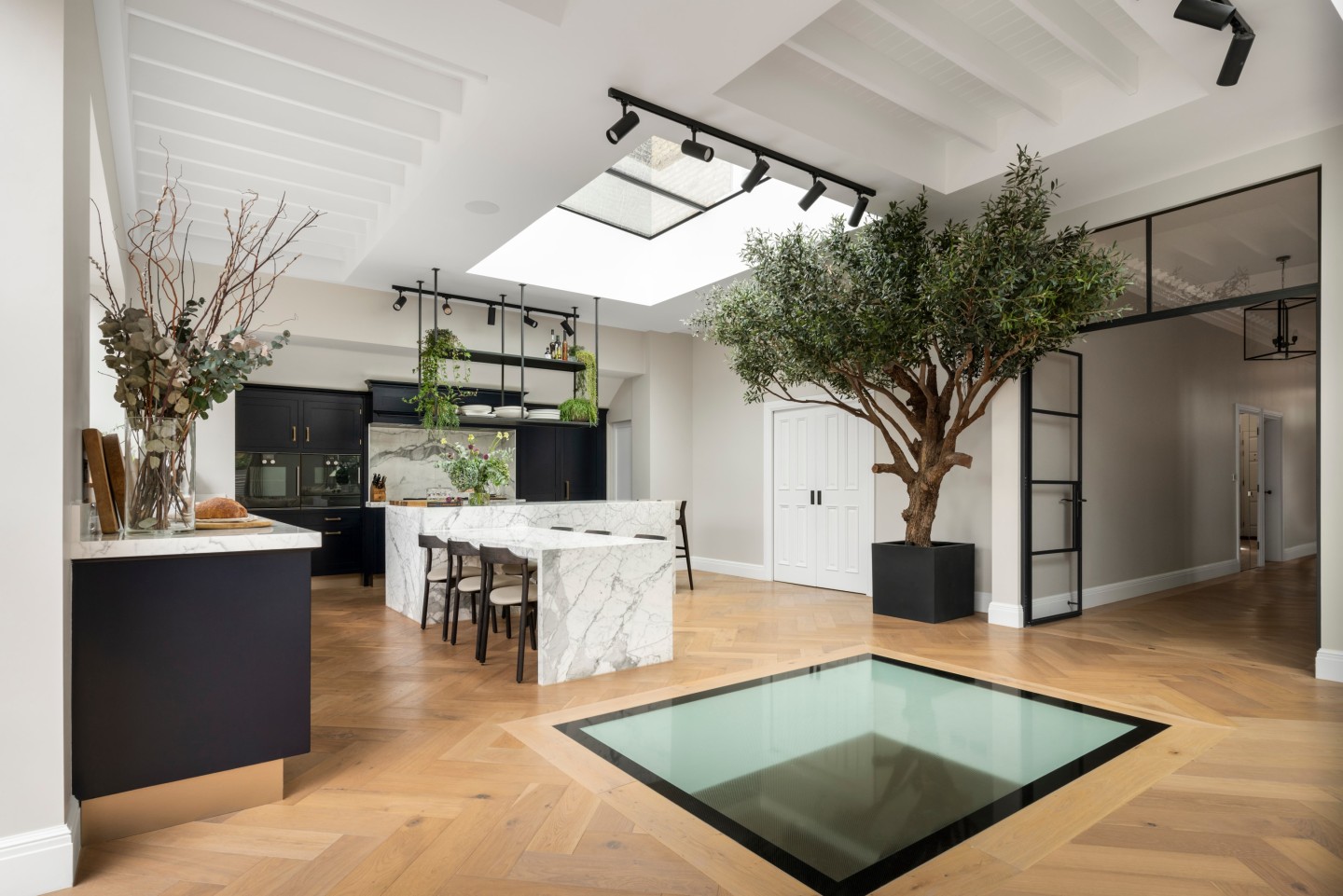 an artificial tree on display in a large kitchen